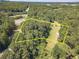 Aerial view of a wooded lot with a marked boundary at 990 Bramlett Shoals Rd, Lawrenceville, GA 30045