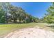 Large, grassy backyard with a sandy play area at 990 Bramlett Shoals Rd, Lawrenceville, GA 30045