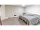 Simple basement bedroom with a queen bed and gray carpeting at 990 Bramlett Shoals Rd, Lawrenceville, GA 30045