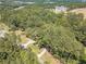 Aerial view of property with wooded lot and neighborhood in the background at 990 Bramlett Shoals Rd, Lawrenceville, GA 30045