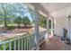 Relaxing front porch with brick flooring and white columns at 990 Bramlett Shoals Rd, Lawrenceville, GA 30045