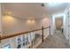 Upstairs hallway with wood railing and carpeted floor at 990 Bramlett Shoals Rd, Lawrenceville, GA 30045