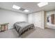 Spacious basement bedroom with a queen-size bed and gray carpet at 990 Bramlett Shoals Rd, Lawrenceville, GA 30045