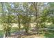 Open backyard with lush trees and a swing at 990 Bramlett Shoals Rd, Lawrenceville, GA 30045