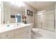 Bathroom with white vanity, tub, shower, and a large mirror at 990 Bramlett Shoals Rd, Lawrenceville, GA 30045