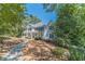 Two-story house with white siding, large windows, and porch at 990 Bramlett Shoals Rd, Lawrenceville, GA 30045