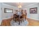 Bright dining room with hardwood floors, a chandelier, and large windows at 990 Bramlett Shoals Rd, Lawrenceville, GA 30045