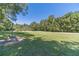 Large backyard featuring a grassy area and trees at 990 Bramlett Shoals Rd, Lawrenceville, GA 30045