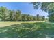 Large grassy backyard with mature trees at 990 Bramlett Shoals Rd, Lawrenceville, GA 30045