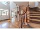 Open staircase with hardwood floors and a wooden railing at 990 Bramlett Shoals Rd, Lawrenceville, GA 30045