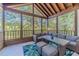 Relaxing screened porch with wicker furniture and wooded views at 990 Bramlett Shoals Rd, Lawrenceville, GA 30045