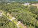 Aerial view of a wooded lot with a marked boundary and driveway at 990 Bramlett Shoals Rd, Lawrenceville, GA 30045