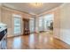 Bright dining room with hardwood floors, a chandelier, and large windows at 990 Bramlett Shoals Rd, Lawrenceville, GA 30045