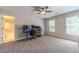 Bedroom with a workspace setup, carpeted floor, and large windows at 990 Bramlett Shoals Rd, Lawrenceville, GA 30045