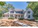 Two-story house with white siding, large windows, and porch at 990 Bramlett Shoals Rd, Lawrenceville, GA 30045