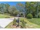 Two-story house with a long driveway and landscaping at 990 Bramlett Shoals Rd, Lawrenceville, GA 30045
