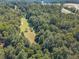 Aerial view of a wooded property with a cleared area at 990 Bramlett Shoals Rd, Lawrenceville, GA 30045