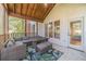 Bright screened porch features comfy seating and access to the home at 990 Bramlett Shoals Rd, Lawrenceville, GA 30045