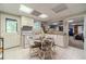 Charming eat-in kitchen in the basement, featuring white cabinets and a view of the Gathering room at 990 Bramlett Shoals Rd, Lawrenceville, GA 30045