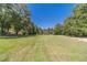 Spacious backyard with lush green grass and mature trees at 990 Bramlett Shoals Rd, Lawrenceville, GA 30045