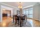 Bright dining room with hardwood floors, a chandelier, and large windows at 990 Bramlett Shoals Rd, Lawrenceville, GA 30045