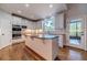 Island kitchen with granite countertops and white cabinets, offering deck access at 990 Bramlett Shoals Rd, Lawrenceville, GA 30045