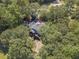 Aerial view of house nestled in woods; deck and stairs visible at 990 Bramlett Shoals Rd, Lawrenceville, GA 30045