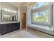 Elegant bathroom with soaking tub, double vanity, and large window at 990 Bramlett Shoals Rd, Lawrenceville, GA 30045