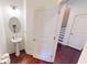 Small powder room with pedestal sink and oval mirror at 51 S Auburn Landing Pl # 51, Auburn, GA 30011