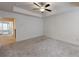 Bright bedroom featuring a ceiling fan and access to hallway at 51 S Auburn Landing Pl # 51, Auburn, GA 30011