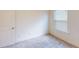 Simple bedroom with a window, carpet, and a door at 51 S Auburn Landing Pl # 51, Auburn, GA 30011