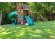 Large wooden playset with slides and swings in grassy backyard at 4396 Highway 166, Douglasville, GA 30135