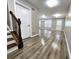 Open concept main living area with hardwood floors and modern staircase at 4024 Towne Creek Cv, Duluth, GA 30097