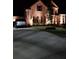 Brick home with landscaped yard and driveway, nighttime view at 6856 Louis Dr, Locust Grove, GA 30248