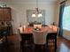 Bright dining room with hardwood floors and large square table at 6856 Louis Dr, Locust Grove, GA 30248