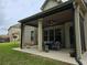 Covered patio with seating area, adjacent to the house at 6856 Louis Dr, Locust Grove, GA 30248