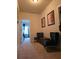 Hallway with two comfortable chairs and view into another room at 6856 Louis Dr, Locust Grove, GA 30248