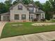 Two-story brick home with landscaped yard and attached garage at 6856 Louis Dr, Locust Grove, GA 30248