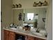 Double vanity bathroom with a large mirror and a view of the shower and bathtub at 6856 Louis Dr, Locust Grove, GA 30248