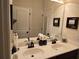 Double vanity bathroom with a large mirror, modern fixtures, and ample counter space at 6856 Louis Dr, Locust Grove, GA 30248