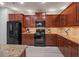 Modern kitchen with granite countertops and dark wood cabinets at 124 Freedom Dr, Acworth, GA 30102