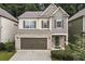 Two-story house with a brown roof, brick facade, and a two-car garage at 124 Freedom Dr, Acworth, GA 30102