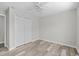 Bedroom with gray walls, vinyl flooring, and double-door closet at 3540 Owl Brow Ct, Cumming, GA 30028