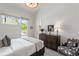 Bright bedroom featuring a dresser and comfortable seating at 10858 Serenbe Ln, Chattahoochee Hills, GA 30268