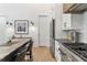 Modern kitchen with stainless steel appliances and granite countertops at 10858 Serenbe Ln, Chattahoochee Hills, GA 30268