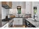 Modern kitchen with gas cooktop and white shaker cabinets at 10858 Serenbe Ln, Chattahoochee Hills, GA 30268