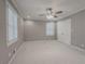 Bright bedroom with ceiling fan, carpeted floors, and double doors at 2052 Rainbow Dr, Snellville, GA 30039