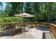 Spacious deck with outdoor dining set, umbrella, and wooded views at 2052 Rainbow Dr, Snellville, GA 30039