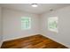 Bright bedroom featuring hardwood floors and two large windows at 4244 Lindsey Dr, Decatur, GA 30035