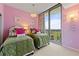 Twin bedroom with pink walls and balcony access at 3300 Windy Ridge Se Pkwy # 1110, Atlanta, GA 30339